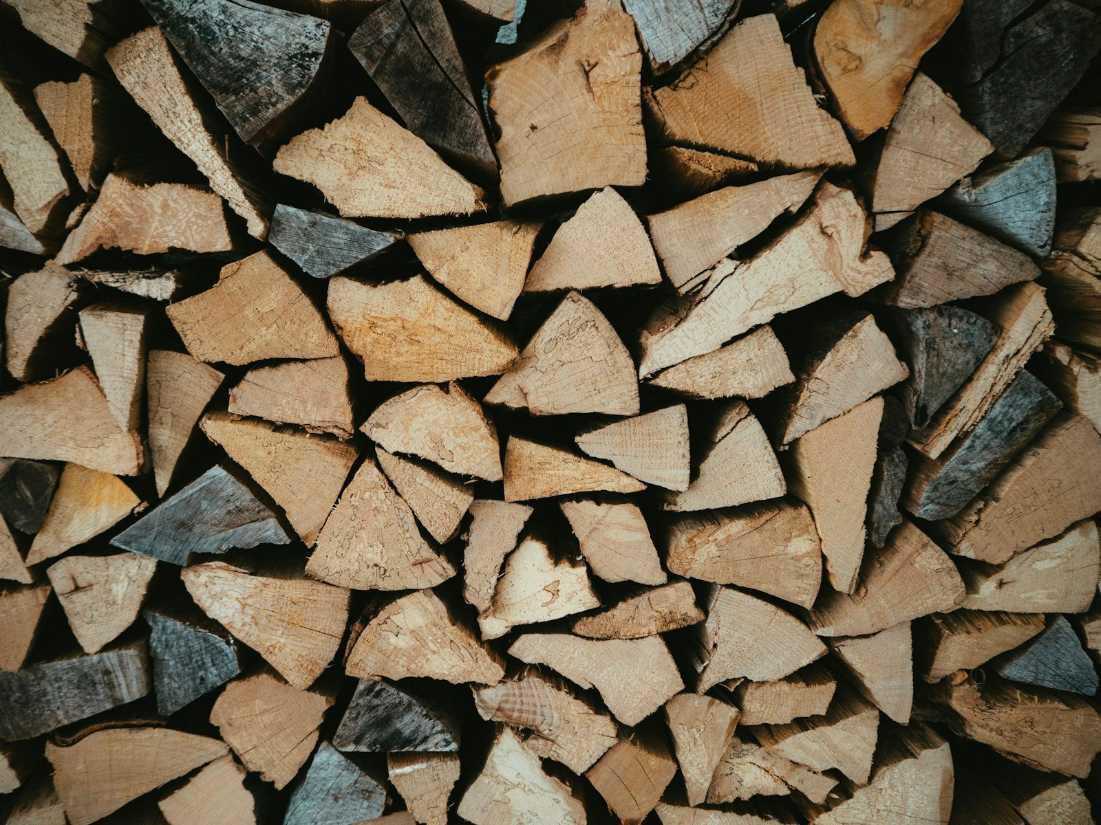Neatly stacked split firewood ready for heating a log cabin through winter